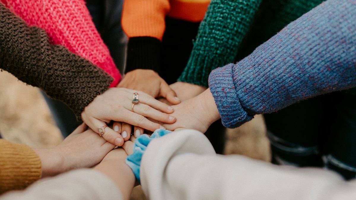 Hands of a group of friends stacked together